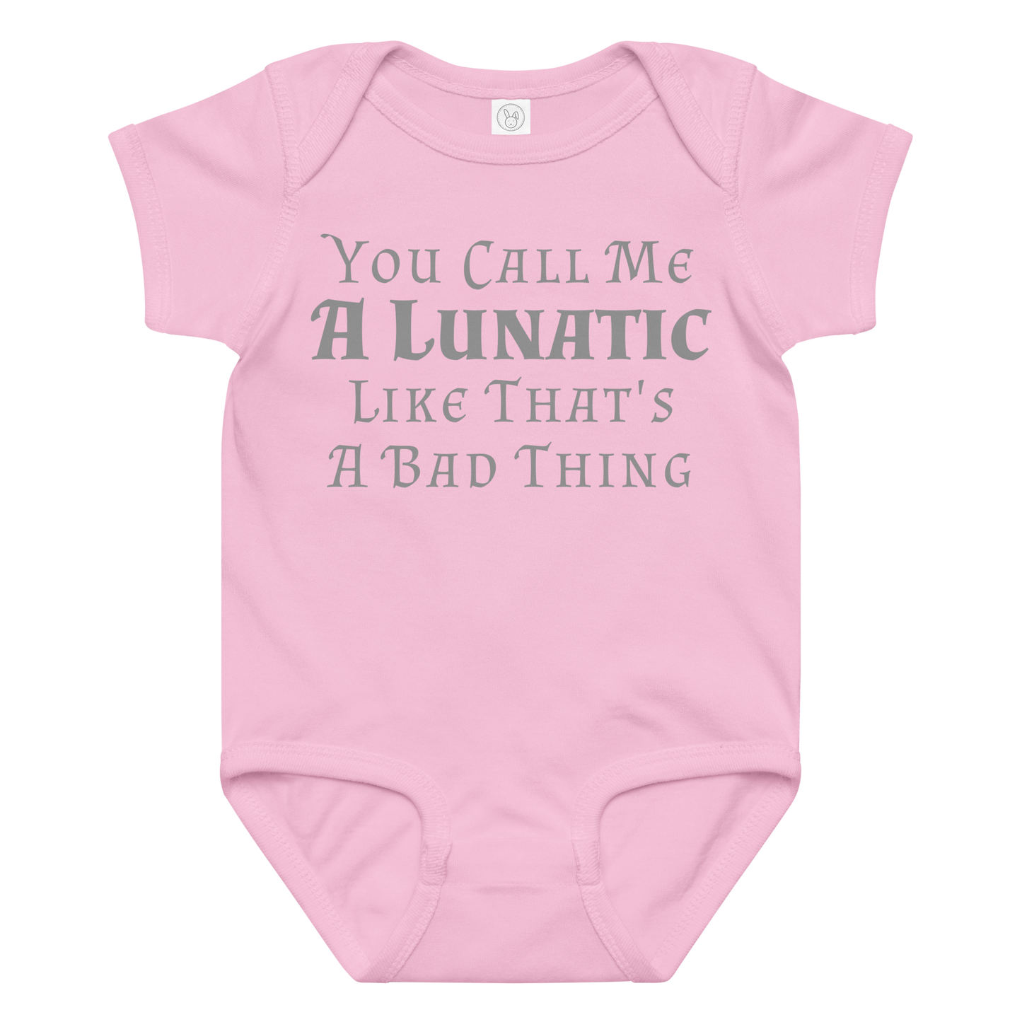 "You Call Me A Lunatic Like That's A Bad Thing" printed on a pink baby jersey bodysuit laying on a flat surface amongst other clothes
