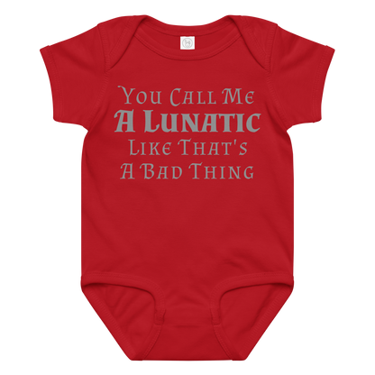 "You Call Me A Lunatic Like That's A Bad Thing" printed on a red baby jersey bodysuit laying on a flat surface amongst other clothes