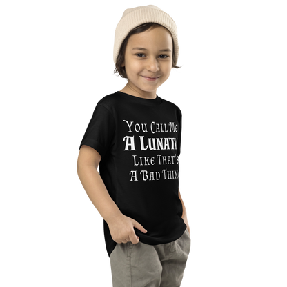 "You Call Me A Lunatic Like That's A Bad Thing" printed on a black toddler short sleeve tee worn by a male who is also wearing a knit cap