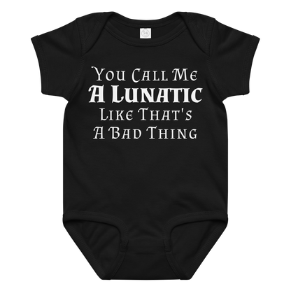 "You Call Me A Lunatic Like That's A Bad Thing" printed on a black baby jersey bodysuit laying on a flat surface amongst other clothes