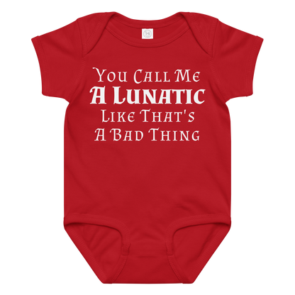 "You Call Me A Lunatic Like That's A Bad Thing" printed on a red baby jersey bodysuit laying on a flat surface amongst other clothes