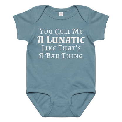 "You Call Me A Lunatic Like That's A Bad Thing" printed on a vintage indigo baby jersey bodysuit laying on a flat surface amongst other clothes