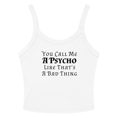"You Call Me A Psycho Like That's A Bad Thing" printed on a solid white blend women's micro-rib tanktop laying on a flat surface amongst sunglasses and shorts