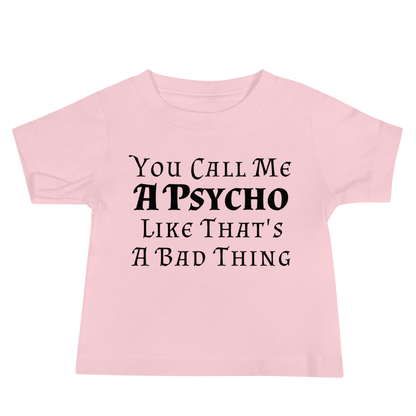 "You Call Me A Psycho Like That's A Bad Thing" printed on a pink baby jersey short sleeve tee laying on a flat surface