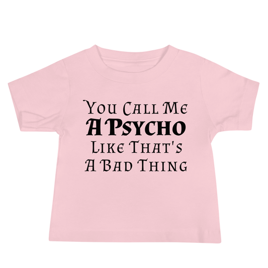 "You Call Me A Psycho Like That's A Bad Thing" printed on a pink baby jersey short sleeve tee laying on a flat surface