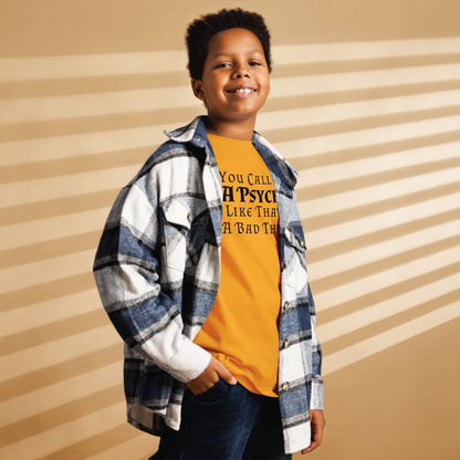 "You Call Me A Psycho Like That's A Bad Thing" printed on a gold youth classic tee worn by a male also wearing a jacket