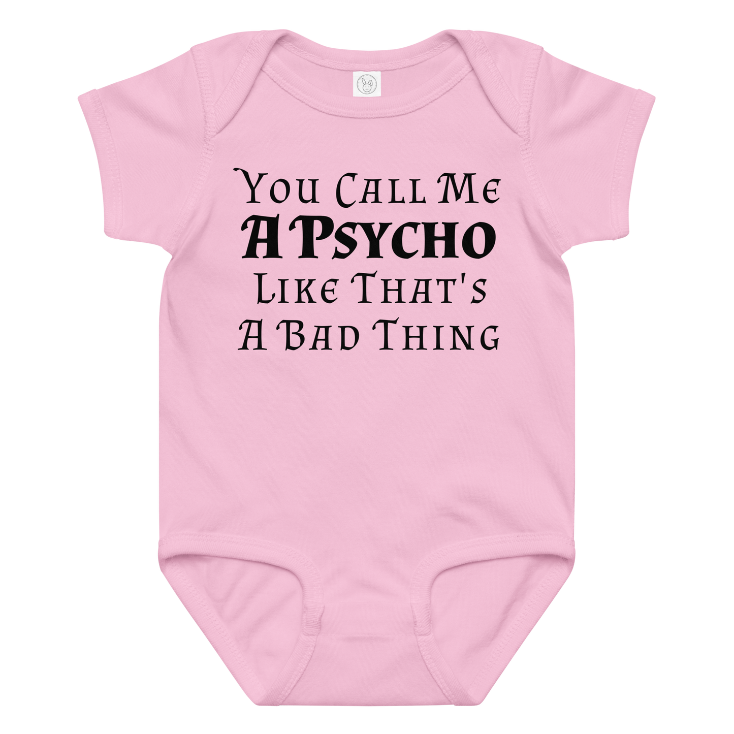 "You Call Me A Psycho Like That's A Bad Thing" printed on a pink baby jersey bodysuit laying on a flat surface amongst other clothes