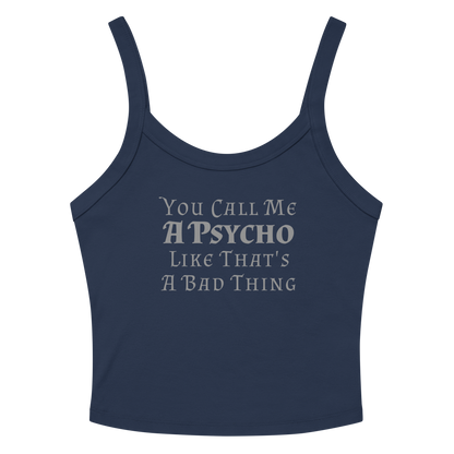 "You Call Me A Psycho Like That's A Bad Thing" printed on a solid navy blend women's micro-rib tanktop laying on a flat surface amongst sunglasses and shorts