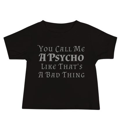 "You Call Me A Psycho Like That's A Bad Thing" printed on a black baby jersey short sleeve tee laying on a flat surface