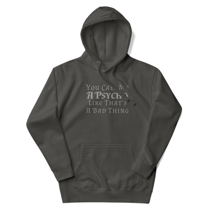 "You Call Me A Psycho Like That's A Bad Thing" printed on a vintage black unisex hoodie laying on a flat surface with the hood up