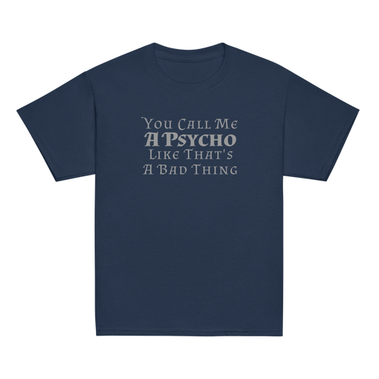 "You Call Me A Psycho Like That's A Bad Thing" printed on a navy youth classic tee laying on a flat surface