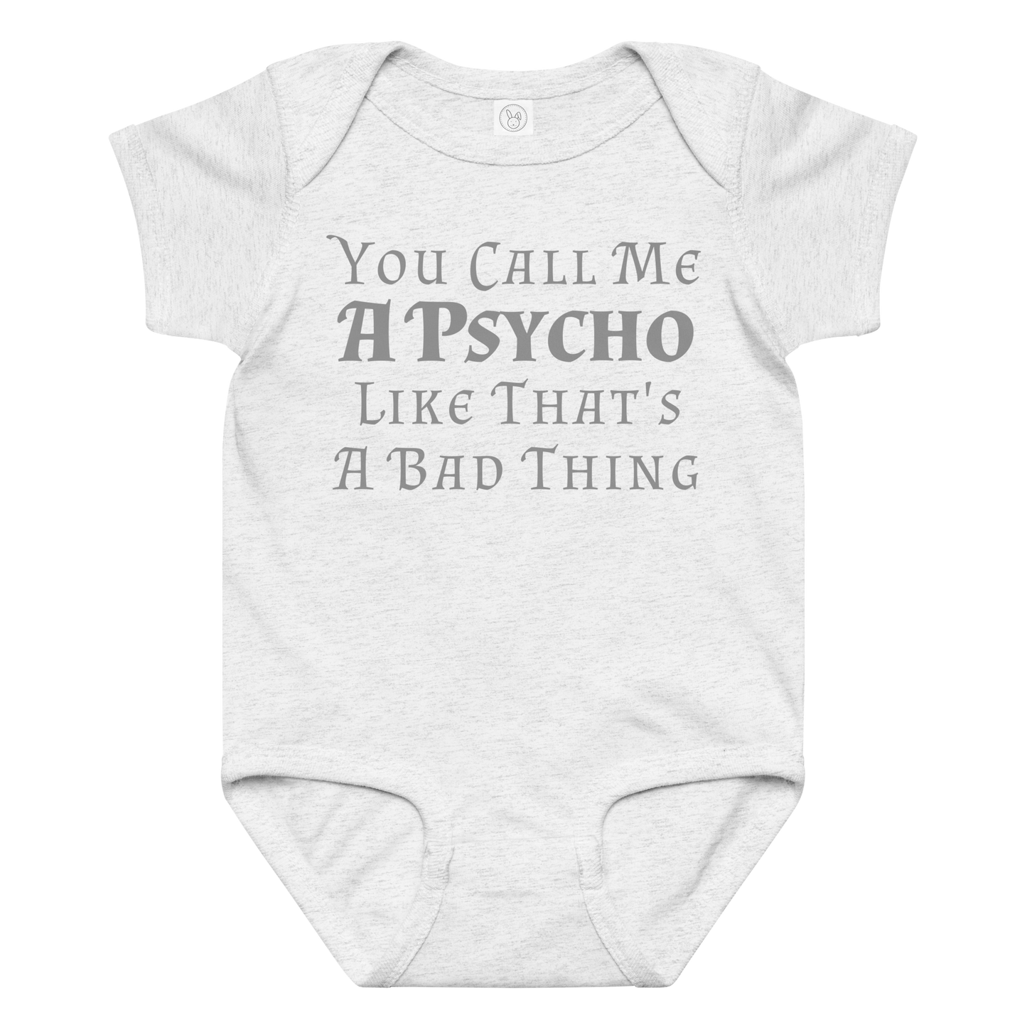 "You Call Me A Psycho Like That's A Bad Thing" printed on a ash baby jersey bodysuit laying on a flat surface amongst other clothes