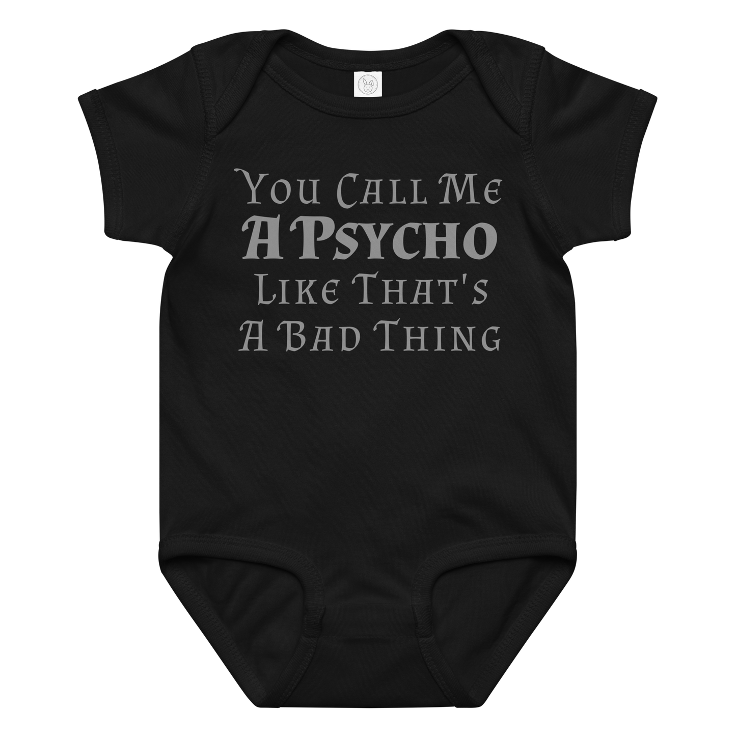 "You Call Me A Psycho Like That's A Bad Thing" printed on a black baby jersey bodysuit laying on a flat surface amongst other clothes