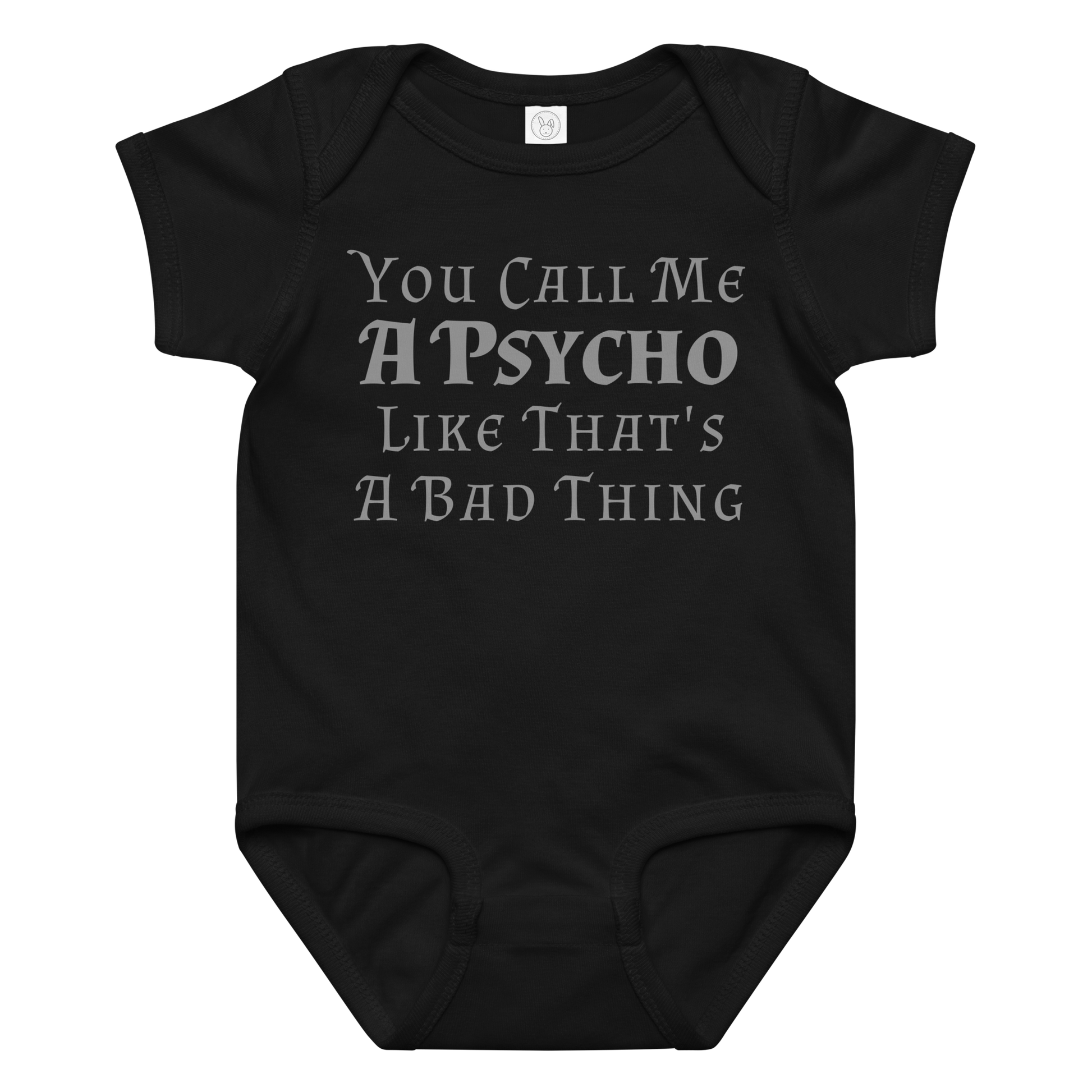 "You Call Me A Psycho Like That's A Bad Thing" printed on a black baby jersey bodysuit laying on a flat surface amongst other clothes