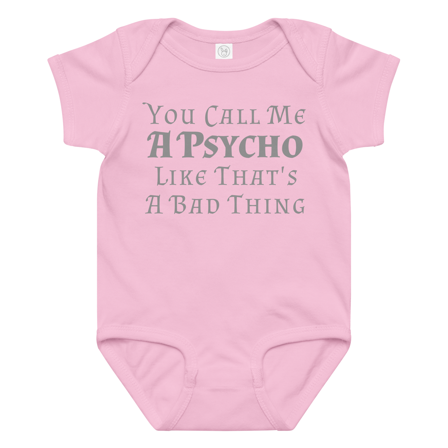 "You Call Me A Psycho Like That's A Bad Thing" printed on a pink baby jersey bodysuit laying on a flat surface amongst other clothes