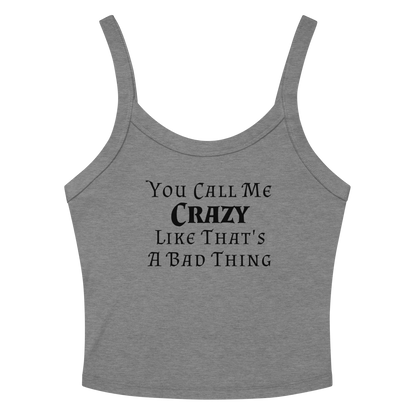 "You Call Me Crazy Like That's A Bad Thing" printed on a athletic heather women's micro-rib tanktop laying on a flat surface amongst sunglasses and shorts