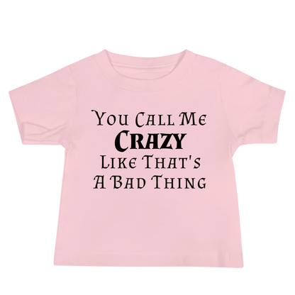 "You Call Me Crazy Like That's A Bad Thing" printed on a pink baby jersey short sleeve tee laying on a flat surface