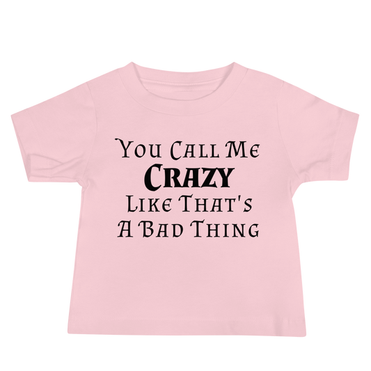 "You Call Me Crazy Like That's A Bad Thing" printed on a pink baby jersey short sleeve tee laying on a flat surface