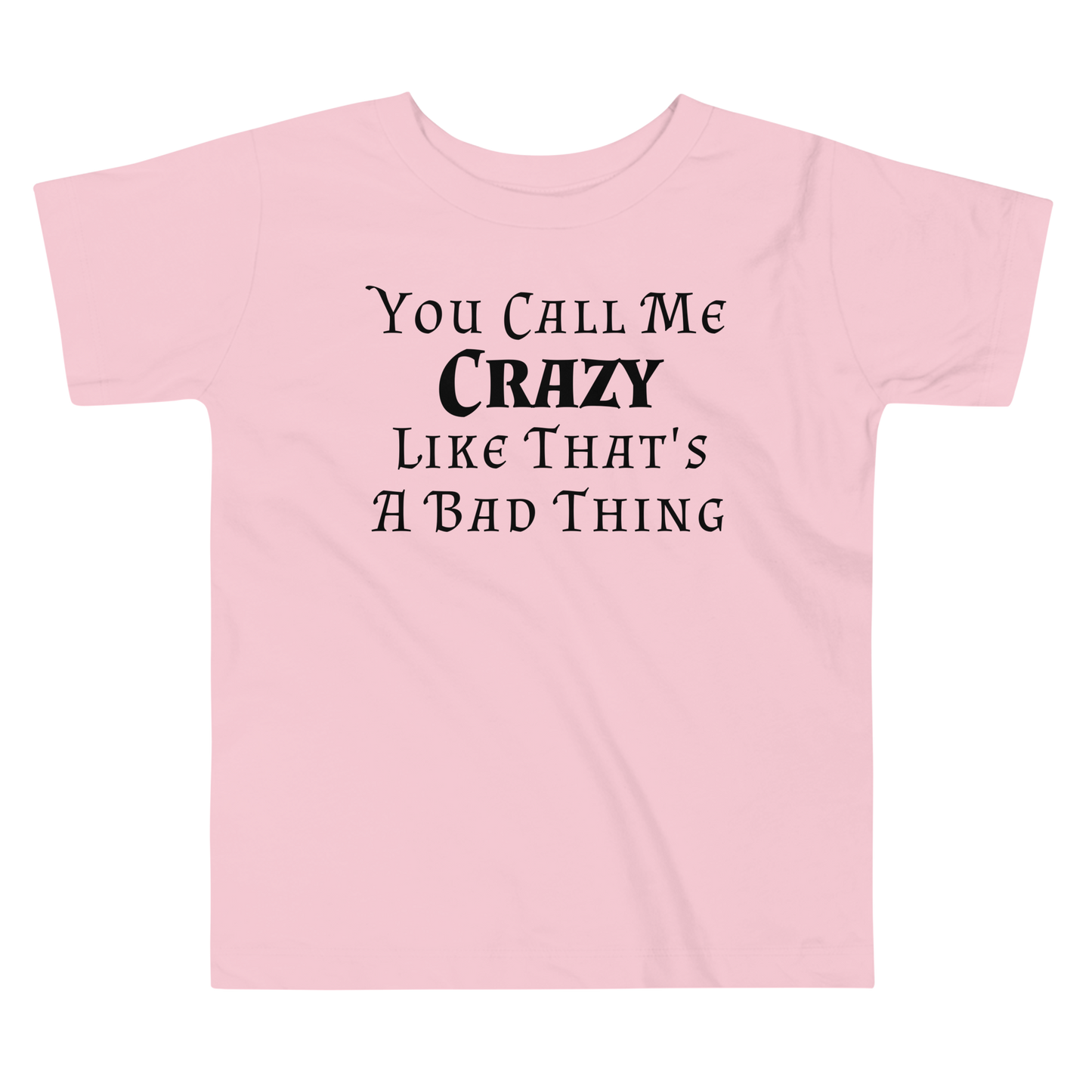 "You Call Me Crazy Like That's A Bad Thing" printed on a pink toddler short sleeve tee laying on a flat surface