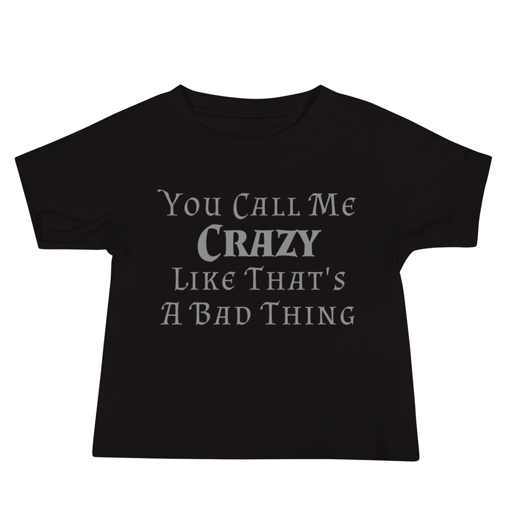 "You Call Me Crazy Like That's A Bad Thing" printed on a black baby jersey short sleeve tee laying on a flat surface