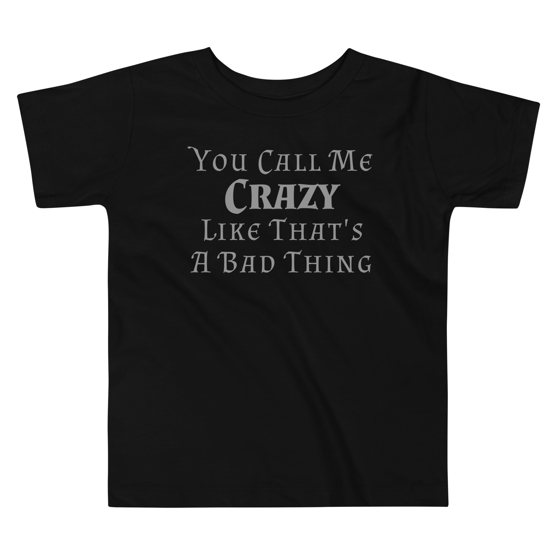 "You Call Me Crazy Like That's A Bad Thing" printed on a black toddler short sleeve tee laying on a flat surface