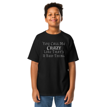 "You Call Me Crazy Like That's A Bad Thing" printed on a black youth classic tee worn by a male