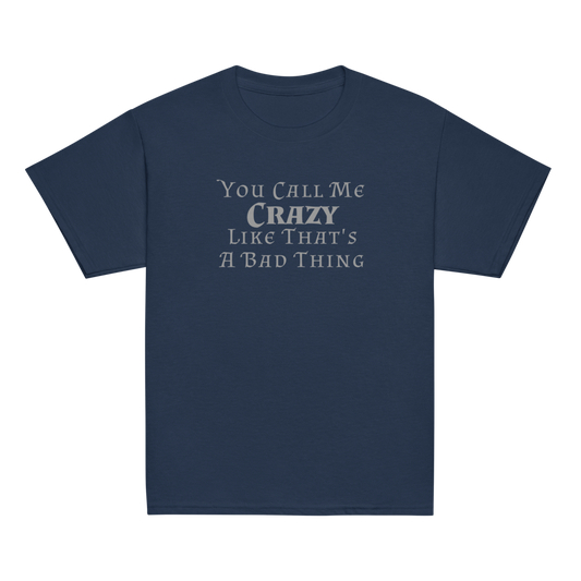 "You Call Me Crazy Like That's A Bad Thing" printed on a navy youth classic tee laying on a flat surface