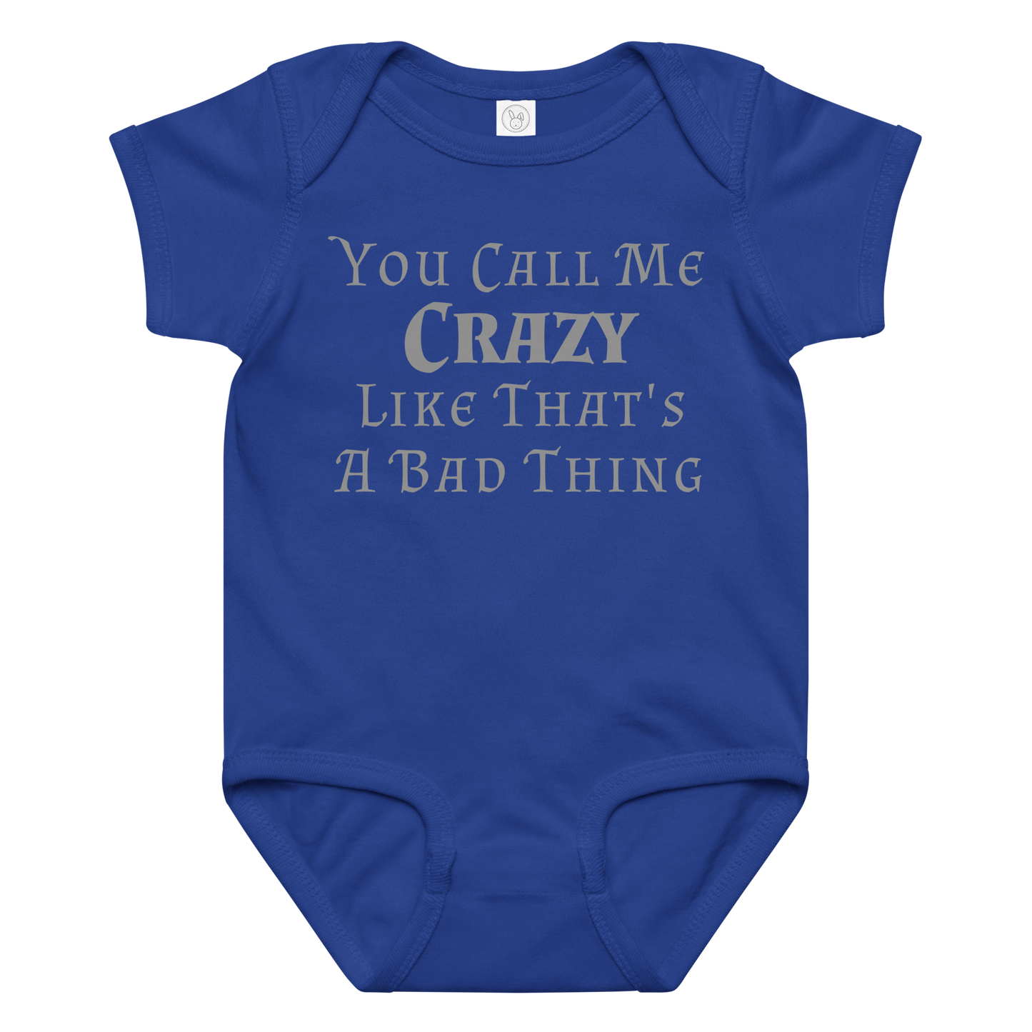"You Call Me Crazy Like That's A Bad Thing" printed on a royal baby jersey bodysuit laying on a flat surface amongst other clothes