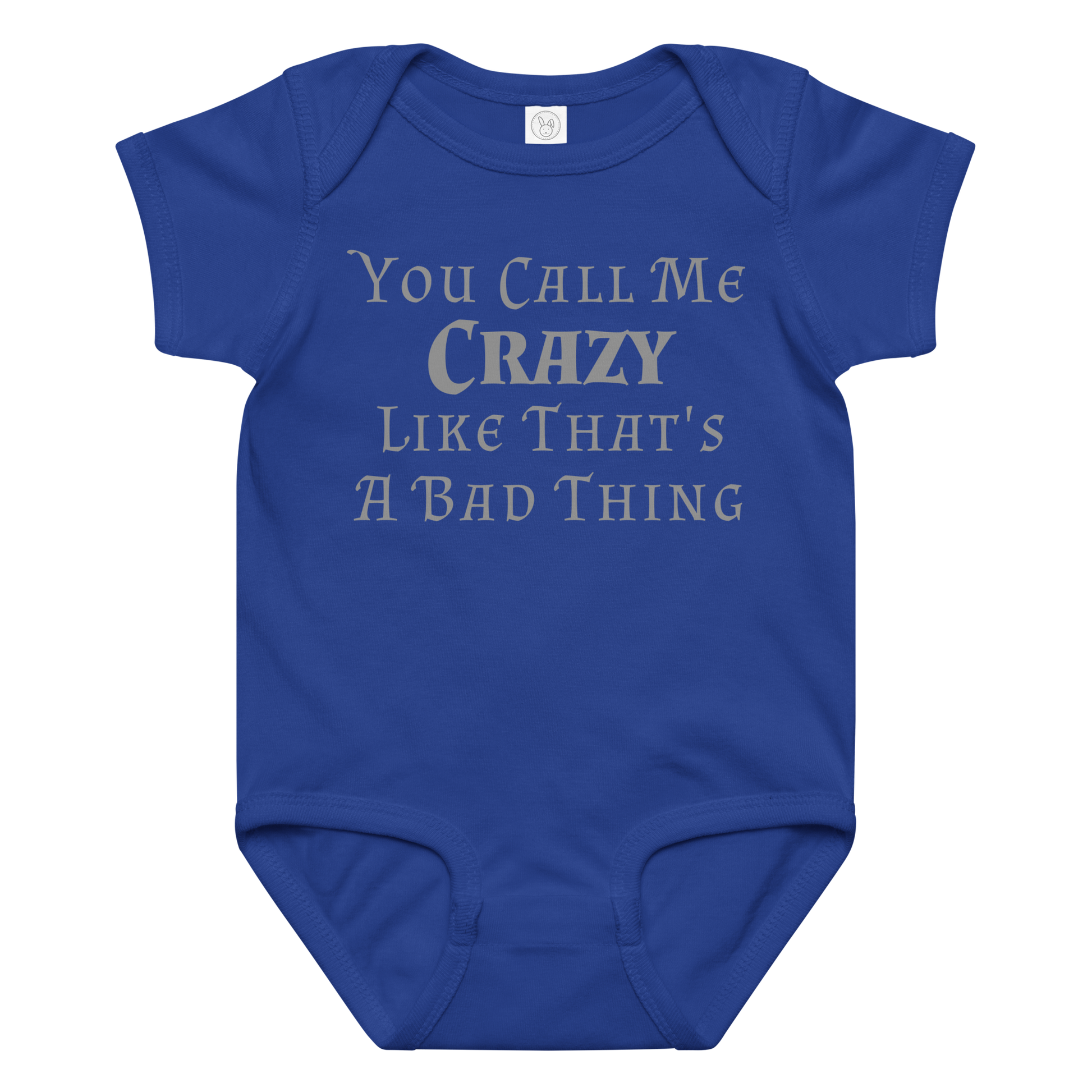 "You Call Me Crazy Like That's A Bad Thing" printed on a royal baby jersey bodysuit laying on a flat surface amongst other clothes