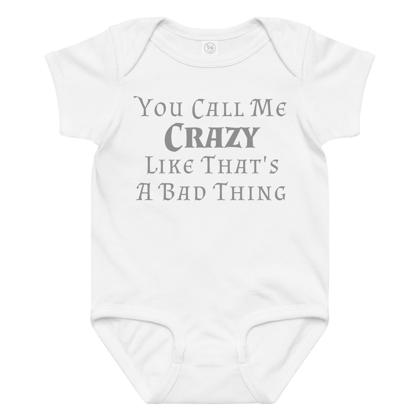 "You Call Me Crazy Like That's A Bad Thing" printed on a white baby jersey bodysuit laying on a flat surface amongst other clothes