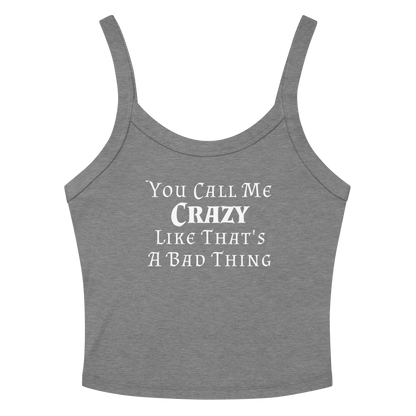 "You Call Me Crazy Like That's A Bad Thing" printed on a athletic heather women's micro-rib tanktop laying on a flat surface amongst sunglasses and shorts