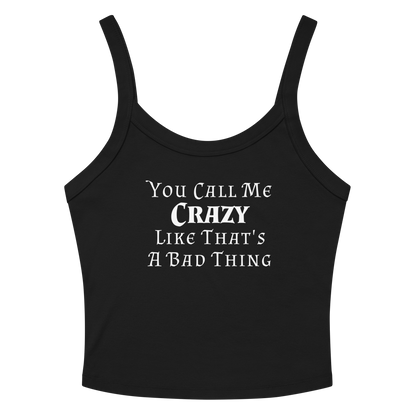 "You Call Me Crazy Like That's A Bad Thing" printed on a solid black blend women's micro-rib tanktop laying on a flat surface amongst sunglasses and shorts