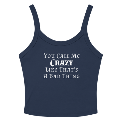 "You Call Me Crazy Like That's A Bad Thing" printed on a solid navy blend women's micro-rib tanktop laying on a flat surface amongst sunglasses and shorts