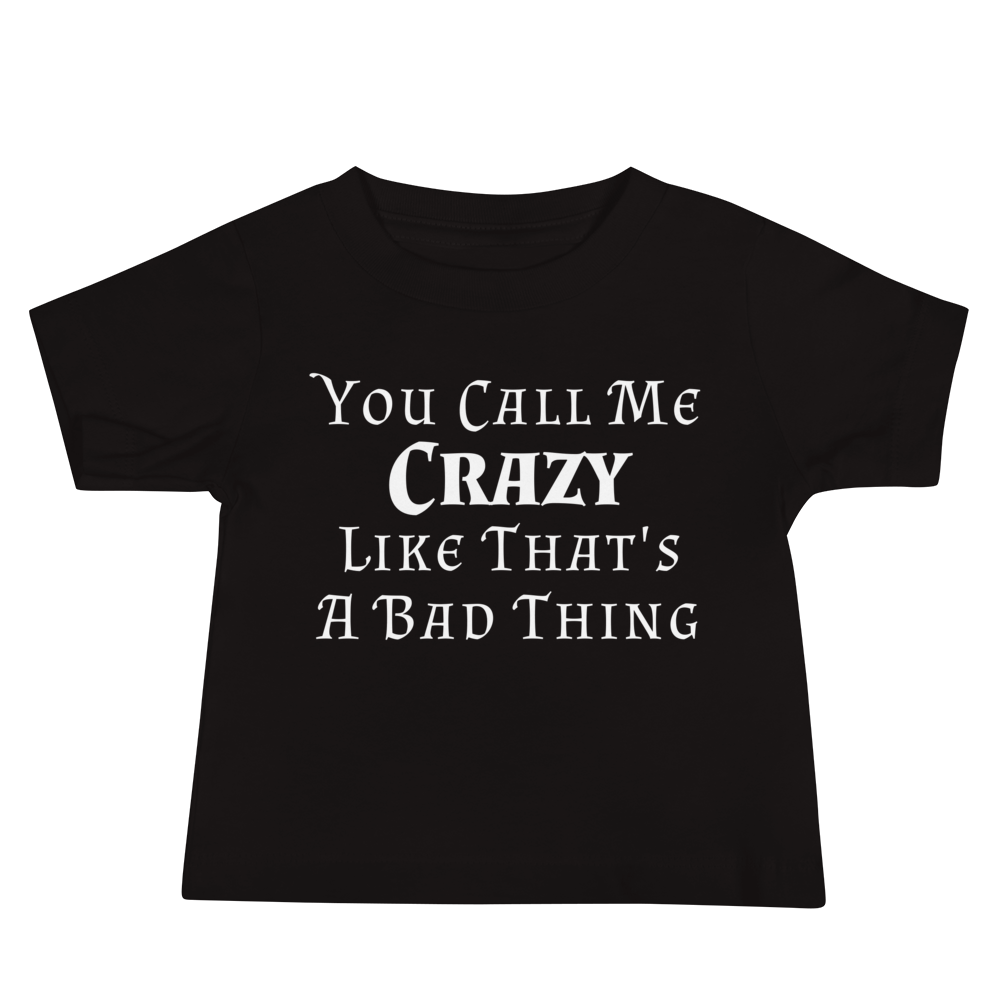 "You Call Me Crazy Like That's A Bad Thing" printed on a black baby jersey short sleeve tee laying on a flat surface