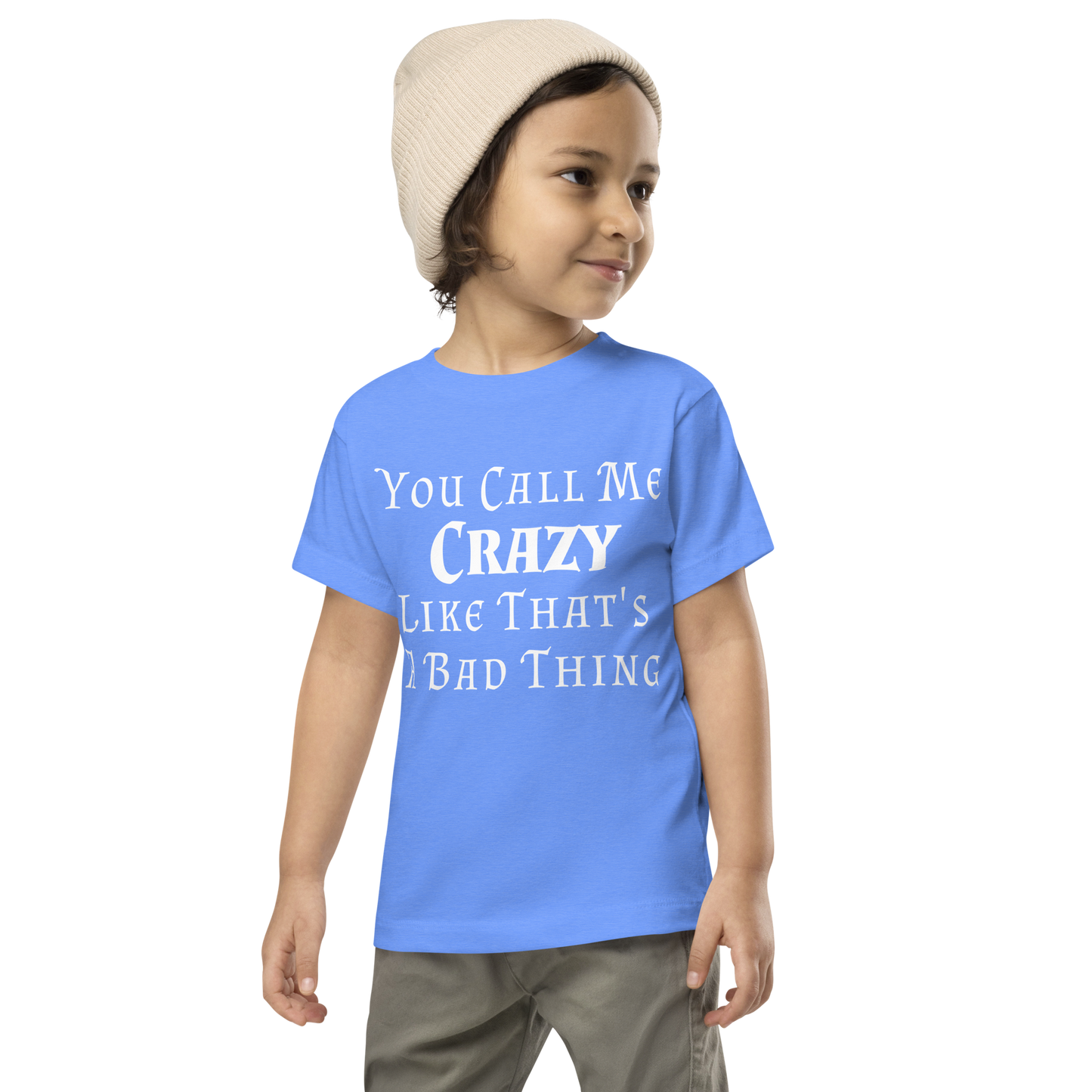 "You Call Me Crazy Like That's A Bad Thing" printed on a heather columbia blue toddler short sleeve tee worn by a male wearing a cap