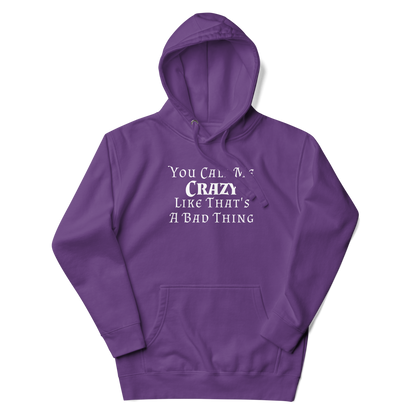 "You Call Me Crazy Like That's A Bad Thing" printed on a purple unisex hoodie laying on a flat surface with the hood up