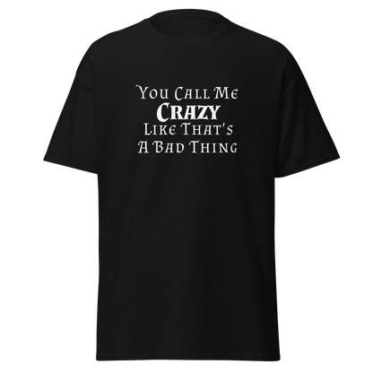 "You Call Me Crazy Like That's A Bad Thing" printed on a black unisex classic tee laying on a flat surface
