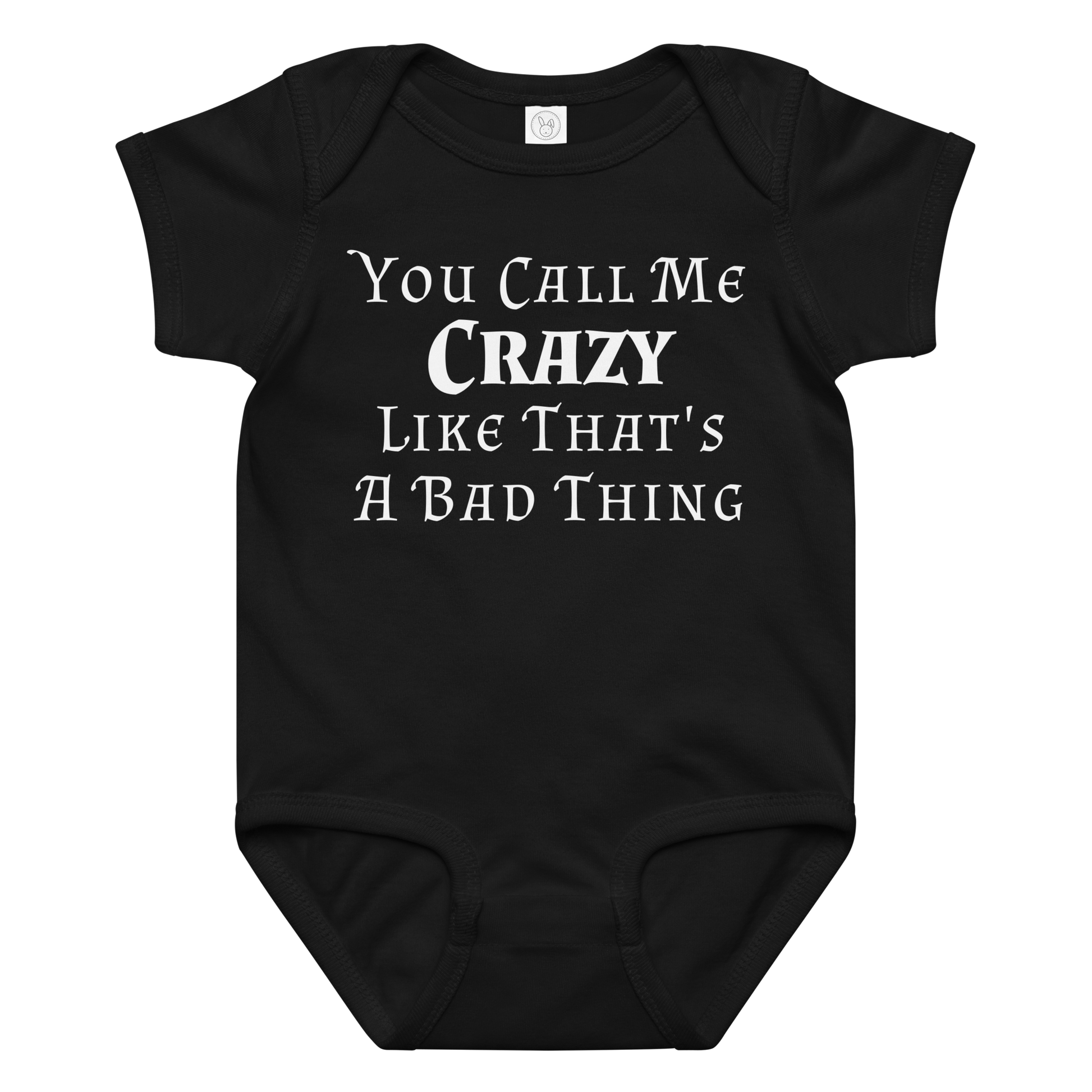 "You Call Me Crazy Like That's A Bad Thing" printed on a black baby jersey bodysuit laying on a flat surface amongst other clothes