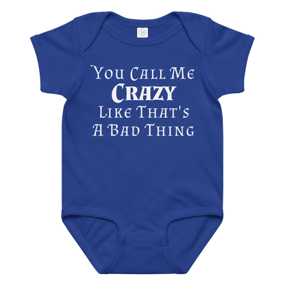 "You Call Me Crazy Like That's A Bad Thing" printed on a royal baby jersey bodysuit laying on a flat surface amongst other clothes