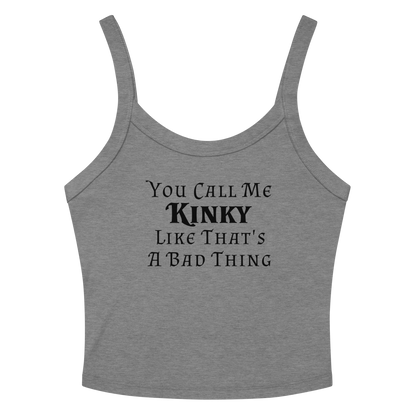 "You Call Me Kinky Like That's A Bad Thing" printed on a athletic heather women's micro-rib tanktop laying on a flat surface amongst sunglasses and shorts