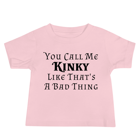 "You Call Me Kinky Like That's A Bad Thing" printed on a pink baby jersey short sleeve tee laying on a flat surface
