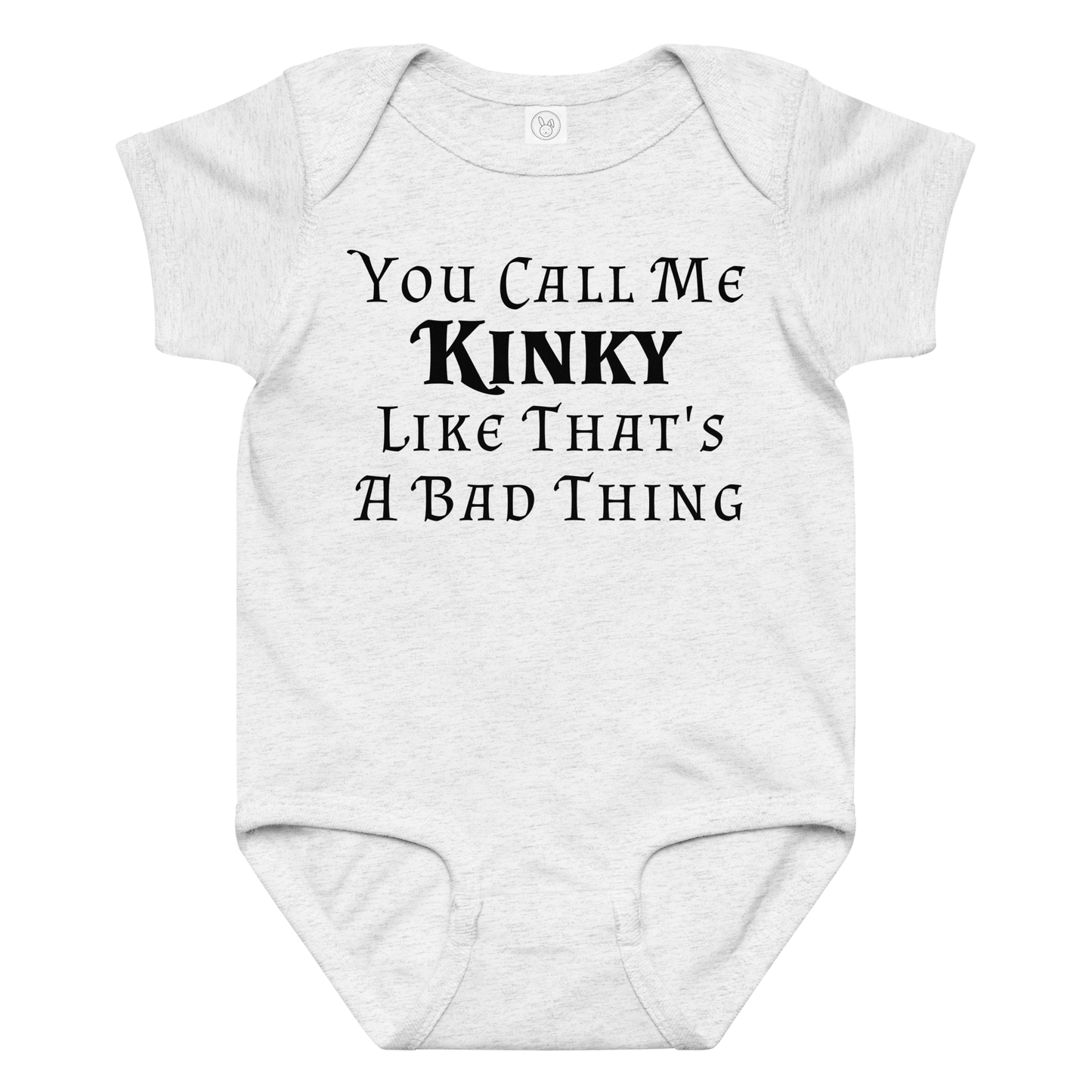 "You Call Me Kinky Like That's A Bad Thing" printed on a ash baby jersey bodysuit laying on a flat surface amongst other clothes