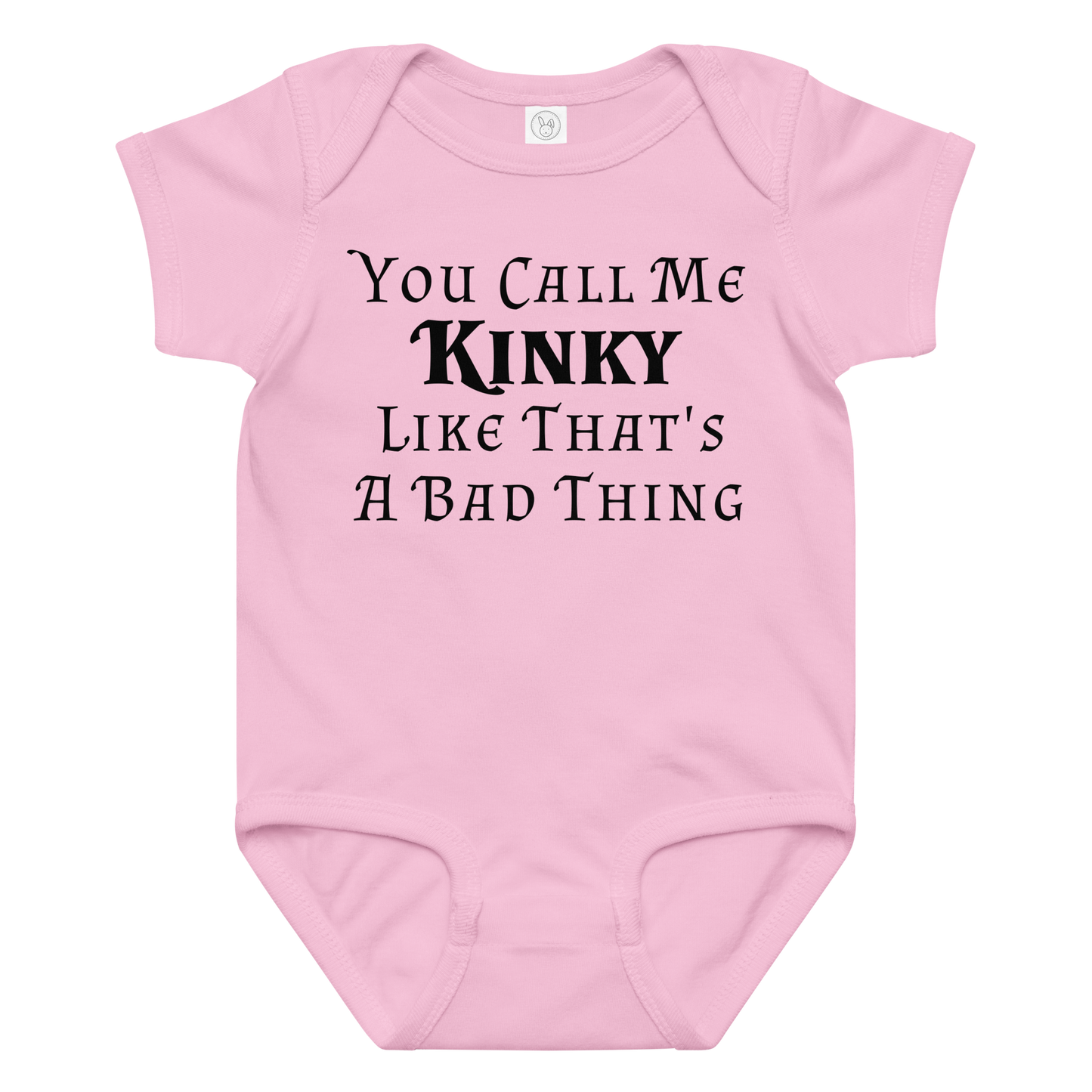 "You Call Me Kinky Like That's A Bad Thing" printed on a pink baby jersey bodysuit laying on a flat surface amongst other clothes