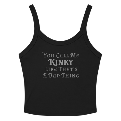 "You Call Me Kinky Like That's A Bad Thing" printed on a solid black blend women's micro-rib tanktop laying on a flat surface amongst sunglasses and shorts
