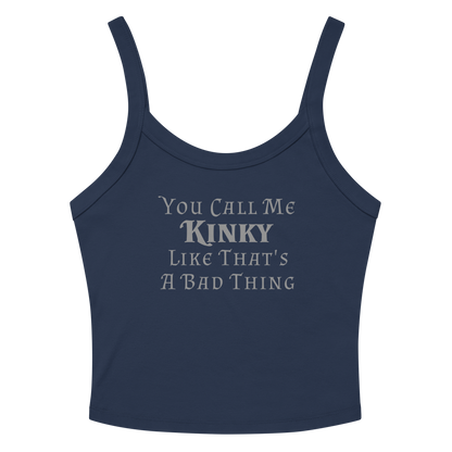 "You Call Me Kinky Like That's A Bad Thing" printed on a solid navy blend women's micro-rib tanktop laying on a flat surface amongst sunglasses and shorts