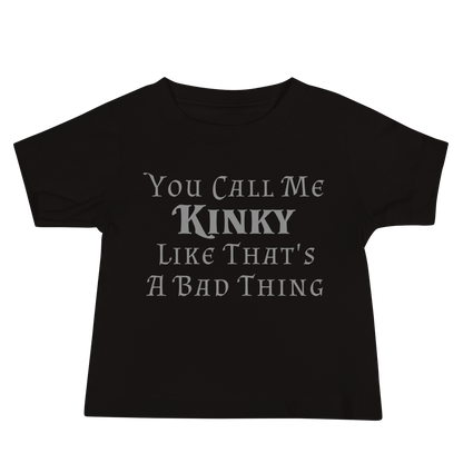 "You Call Me Kinky Like That's A Bad Thing" printed on a black baby jersey short sleeve tee laying on a flat surface