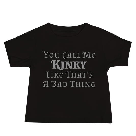 "You Call Me Kinky Like That's A Bad Thing" printed on a black baby jersey short sleeve tee laying on a flat surface