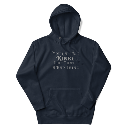 "You Call Me Kinky Like That's A Bad Thing" printed on a navy blazer unisex hoodie laying on a flat surface with the hood up