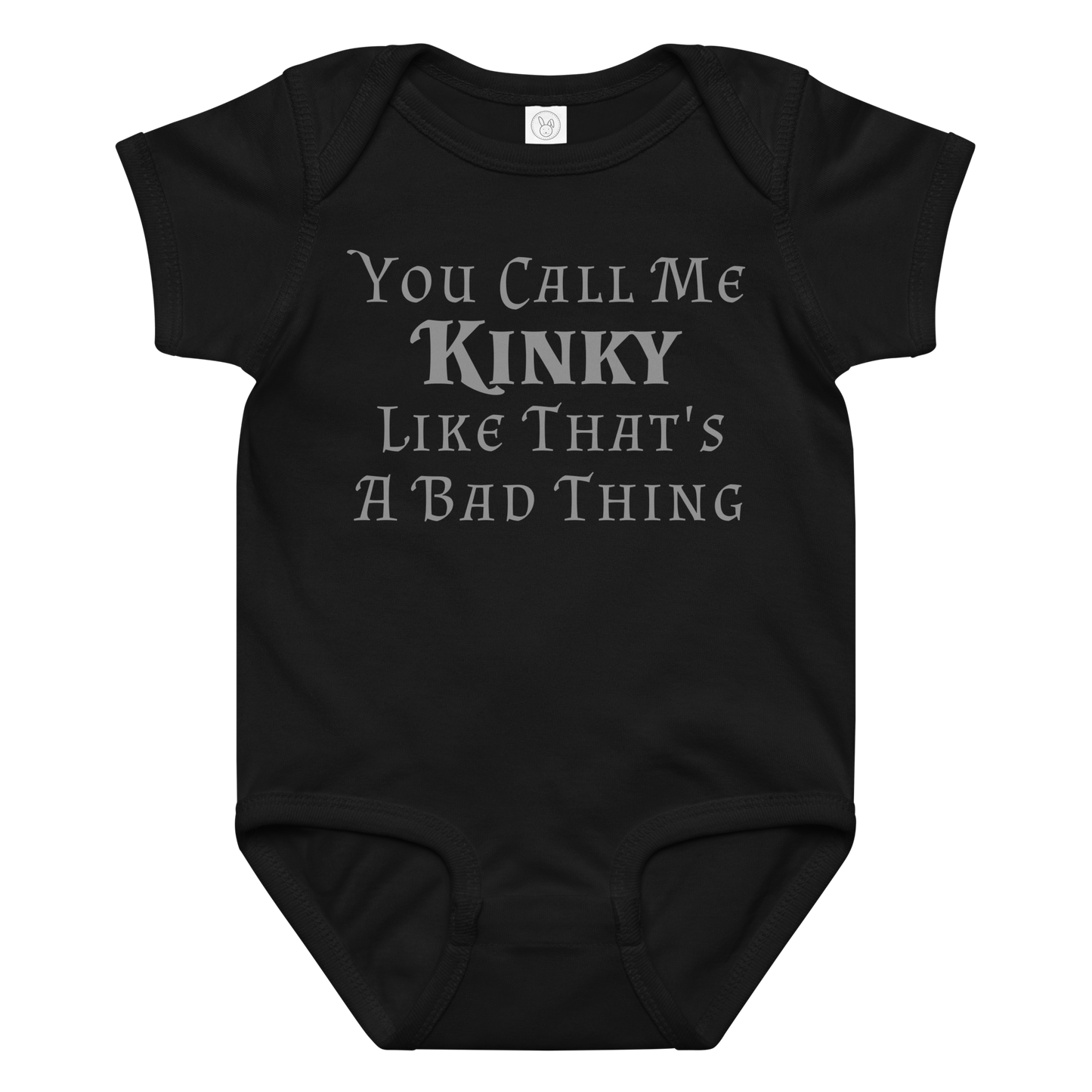 "You Call Me Kinky Like That's A Bad Thing" printed on a black baby jersey bodysuit laying on a flat surface amongst other clothes