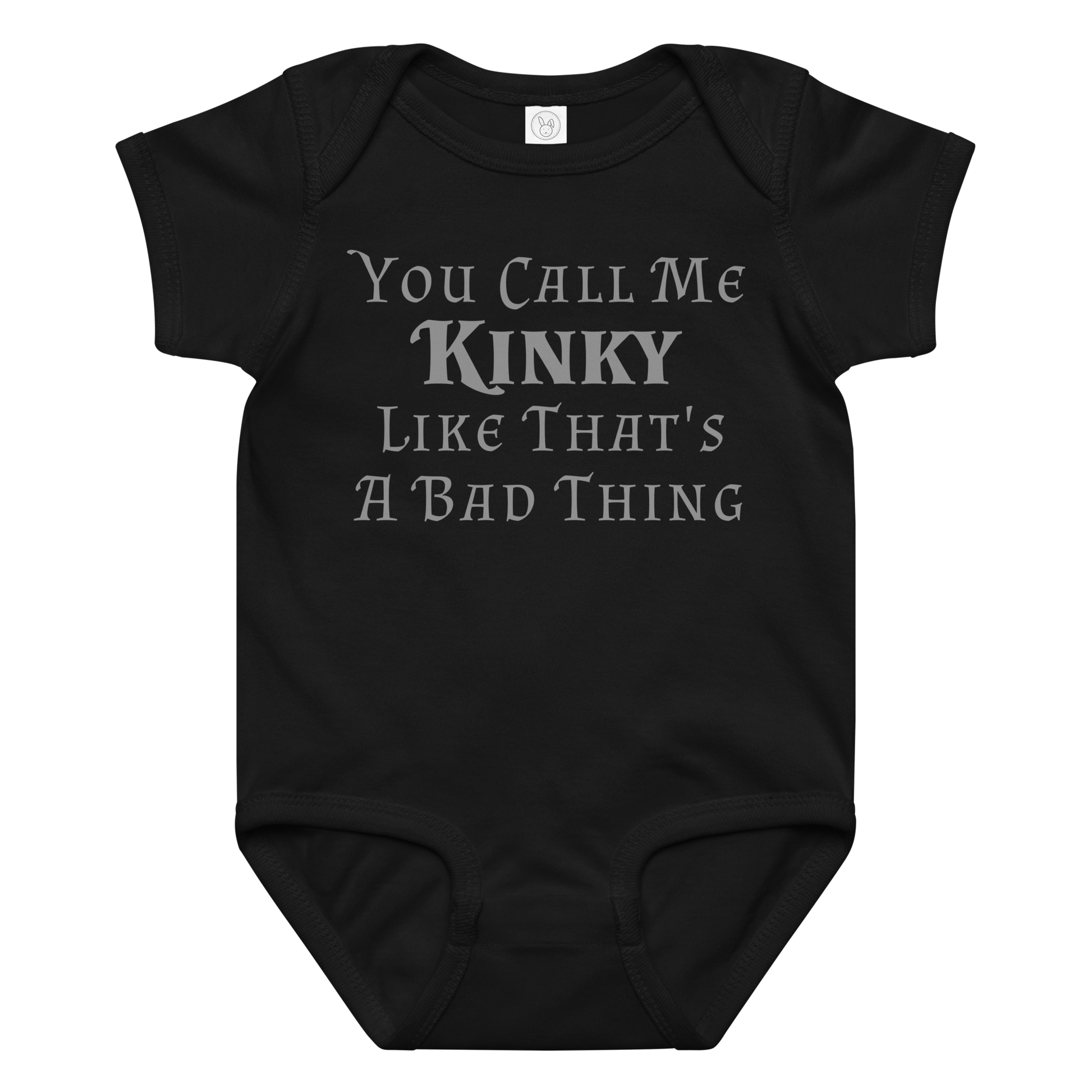 "You Call Me Kinky Like That's A Bad Thing" printed on a black baby jersey bodysuit laying on a flat surface amongst other clothes